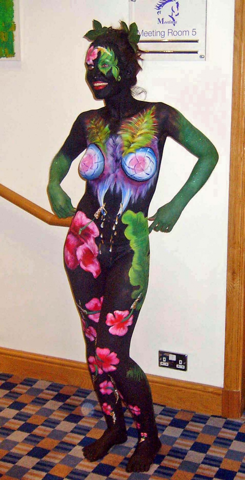 Female model photo shoot of SkinMagic in Bristol.  Hibiscus Flowers and Large Leaf - SkinMagic, makeup by Mark Gannon Body Artist, body painted by mmm wow