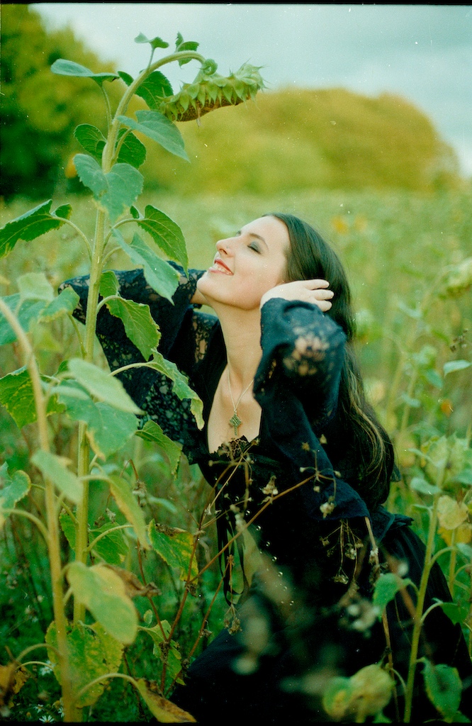 Female model photo shoot of Forsaken desire in A sunflower field near box woods