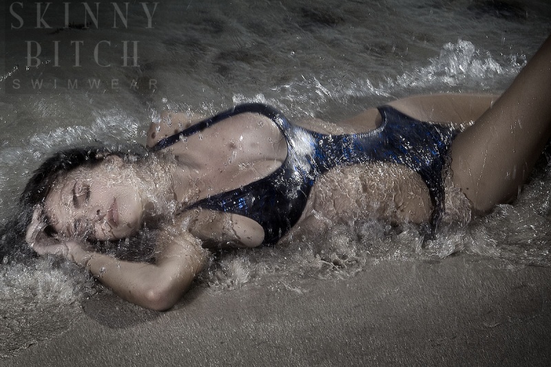 Female model photo shoot of Skinny Bitch Swimwear in the ocean