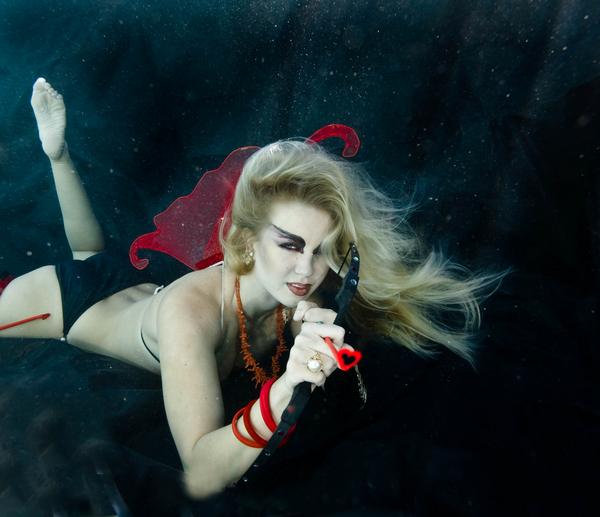 Female model photo shoot of underwater model in Pool