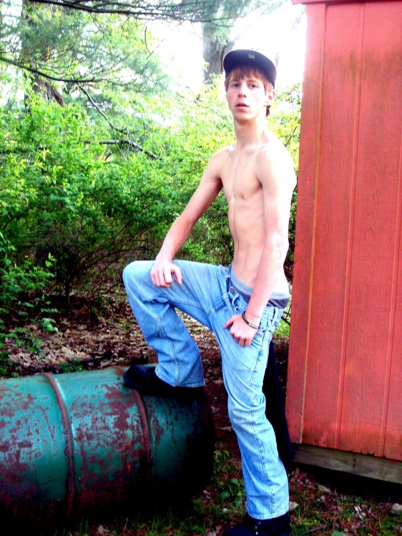 Male model photo shoot of bobby wood in on some barrel behind a building