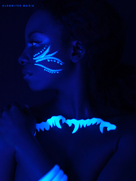 Female model photo shoot of Brittany Oliver and BrittanyOliver by JenniferMaria  in Materials: a blacklight, UV reflective makeup, and paper cut out patterns., makeup by Alexandra Pena