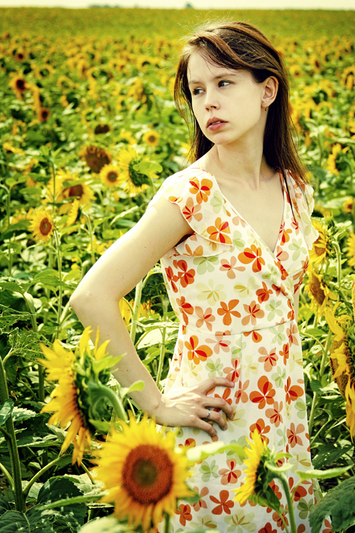 Female model photo shoot of Sarasvita in Sunflower field outside of Regina, Saskatchewan, Canada, makeup by Sara Sestak Makeup Arts