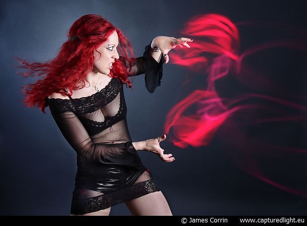 Male and Female model photo shoot of James Corrin and Skarlett Venom in Dark room with glowsticks