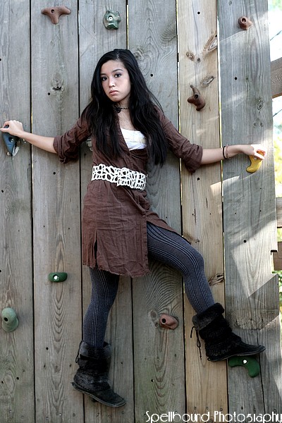 Female model photo shoot of SpellboundPhotography in High school rock wall. Marlton, NJ