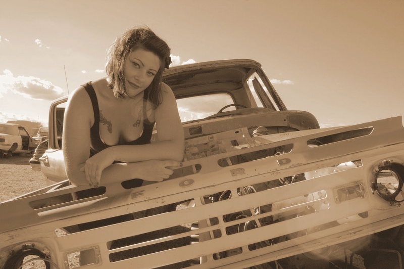 Female model photo shoot of Red Hot Scarlet by Deeeliteful Images in Wickenburg, AZ (junkyard)