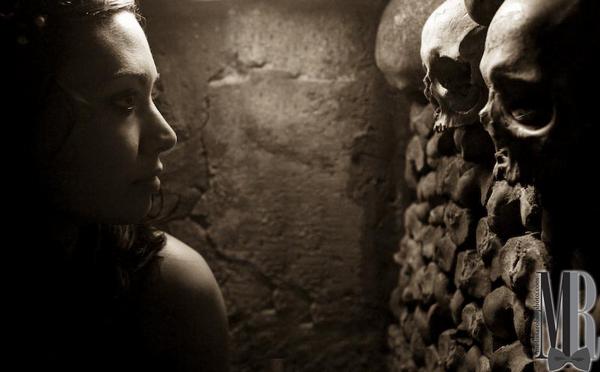 Female model photo shoot of Sarah AK in catacombs