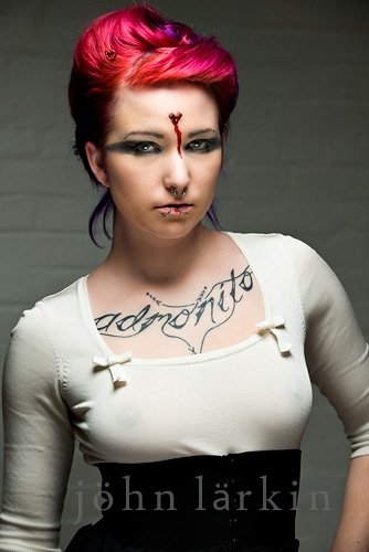 Female model photo shoot of fractale faces and Leo Velo by John Larkin Photography in studio.