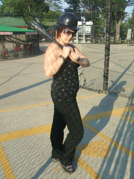 Female model photo shoot of Leash Star in batting cages