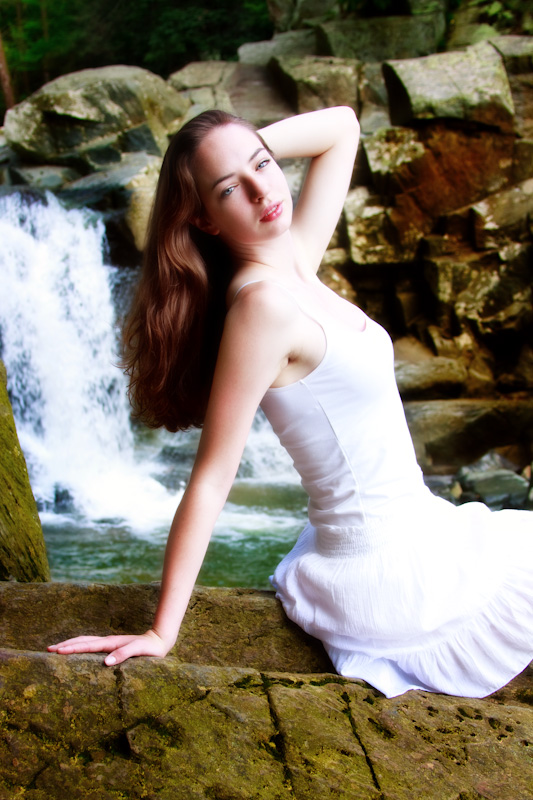 Female model photo shoot of Kaitlin E by Visceral Photography in rocks by a waterfall