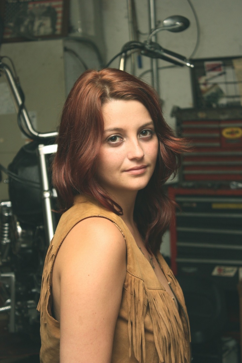 Female model photo shoot of AbsoluteKimsta in  Smittys bike shop. Grant, FL