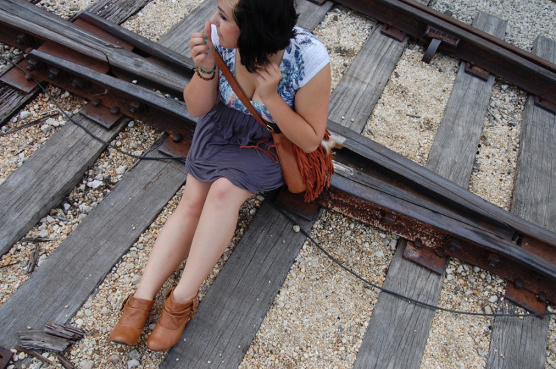 Female model photo shoot of Erika Clair in railroad in town.