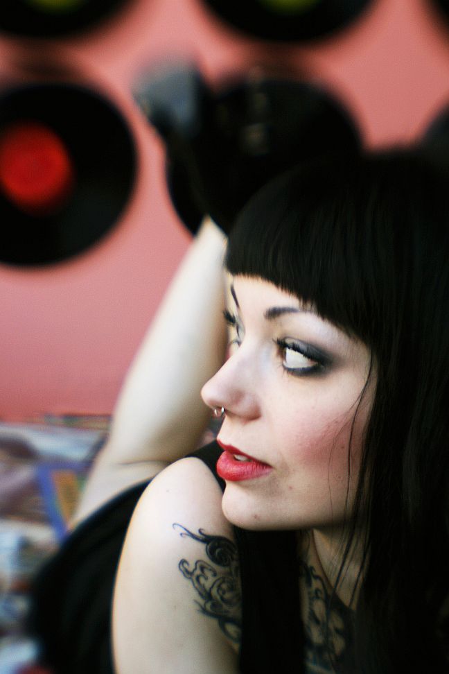 Female model photo shoot of The Violet Noir in On a pile of records