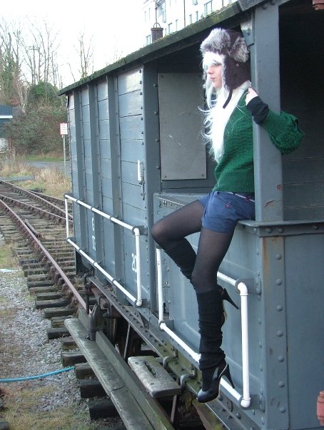 Female model photo shoot of Koto in on an old train by the docks, bristol, UK 