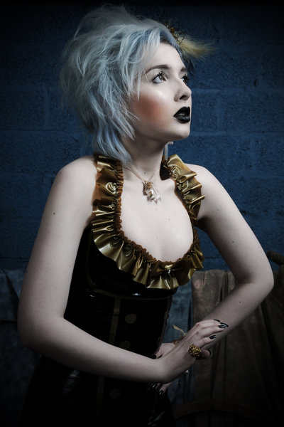 Female model photo shoot of Extacy Photographic and Sophie Roach, hair styled by True-Hair and Make-up, wardrobe styled by valkyrie styling, clothing designed by Sacre Coeur Adornments and Violaceous Latex