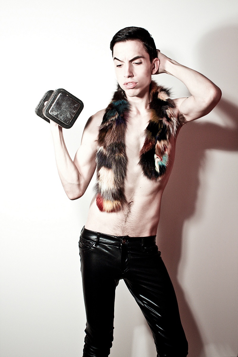 Male model photo shoot of Anthony De La Cruz in Combining faux fur, liquid metallic, and vintage garments parred along soaringly with 4 inch Zip Wedge boots, Photographer Thomas Saints captures me for a stripped down affair.