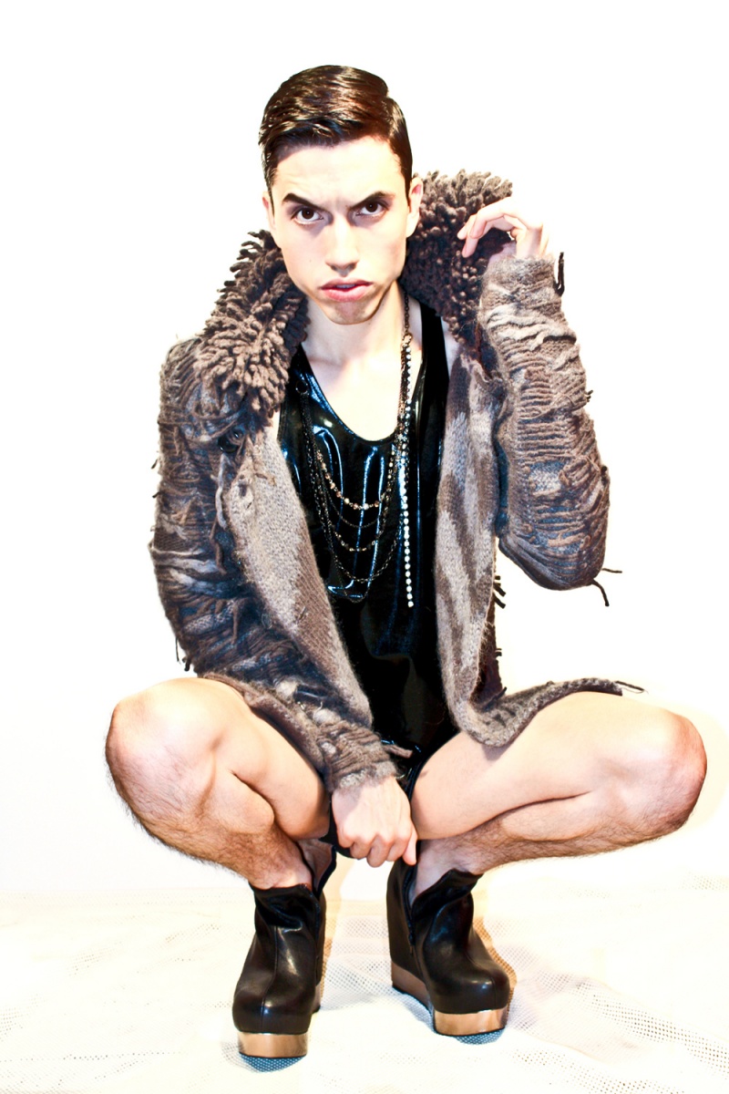 Male model photo shoot of Anthony De La Cruz in Combining faux fur, liquid metallic, and vintage garments parred along soaringly with 4 inch Zip Wedge boots, Photographer Thomas Saints captures me for a stripped down affair.