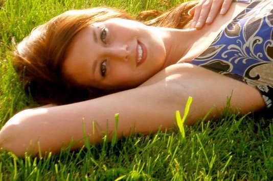 Female model photo shoot of BekkiJo in Laying in the Grass