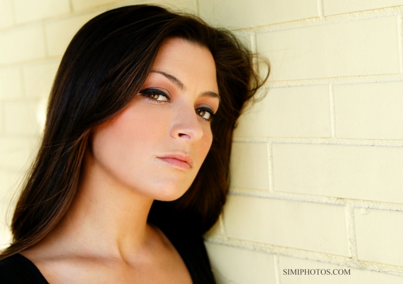 Female model photo shoot of Jehnna by SimiPhotos in awesome yellow brick wall, makeup by Sara Lynn Makeup
