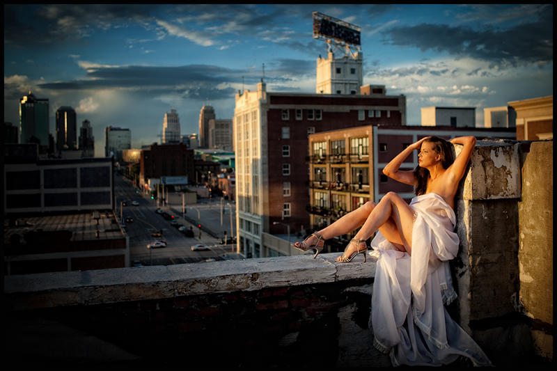 Female model photo shoot of Rebecca Kellogg in roof of K.C Power and Light District