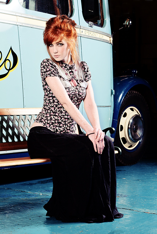 Female model photo shoot of Chrissie-Red in A bus museum, makeup by June Long