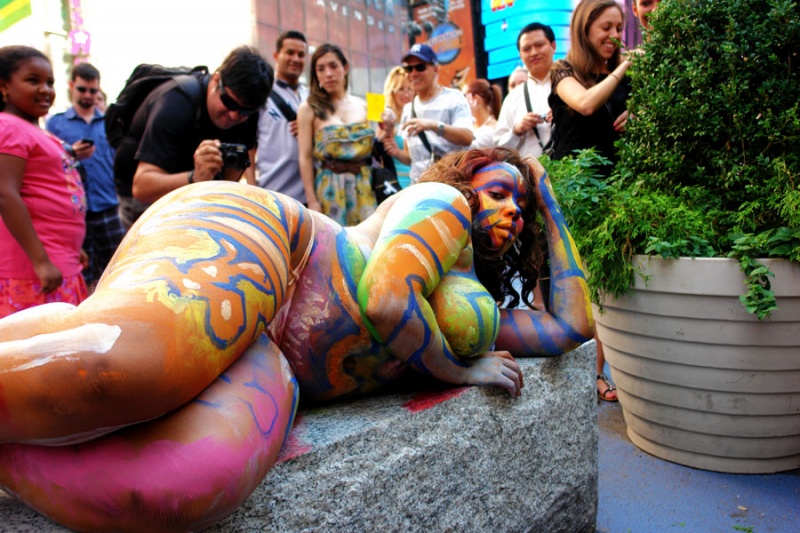 Female model photo shoot of Myoshi in Times Square , body painted by Andy Golub