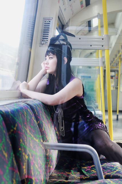 Female model photo shoot of Costume Boutique in London Underground tube train