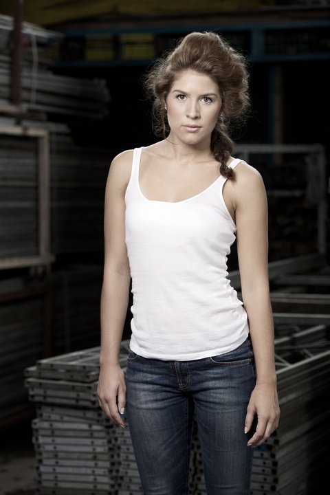 Female model photo shoot of Xandra Low in shipyard storage
