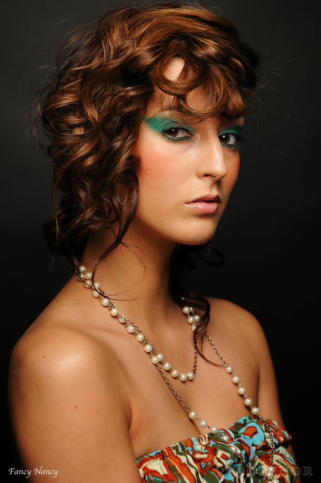 Female model photo shoot of fancy makeup 