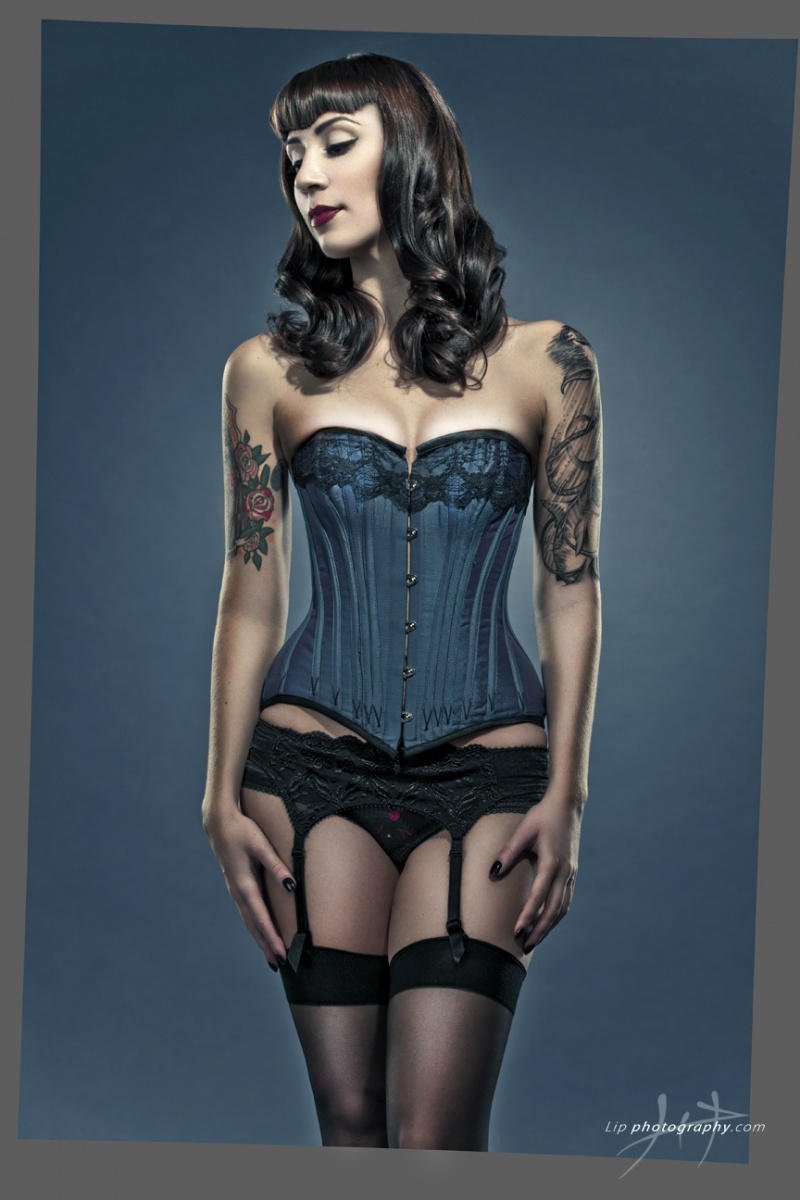 Female model photo shoot of Totally Waisted Corset