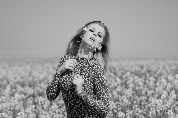 Female model photo shoot of Chessie King by TomSimmonds in Brighton - Rapeseed field, makeup by Lucy Jordan