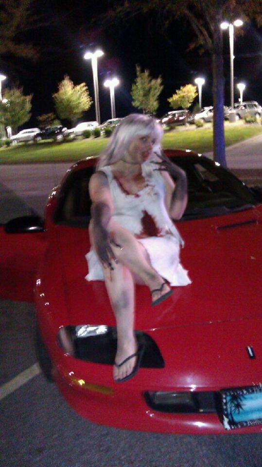 Female model photo shoot of Lilith Love in Zombie walk. Asheville mall.