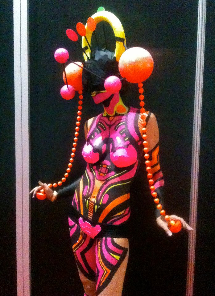 Female model photo shoot of Lekkie in Premiere Beauty Show Orlando, body painted by NIX BODY ART
