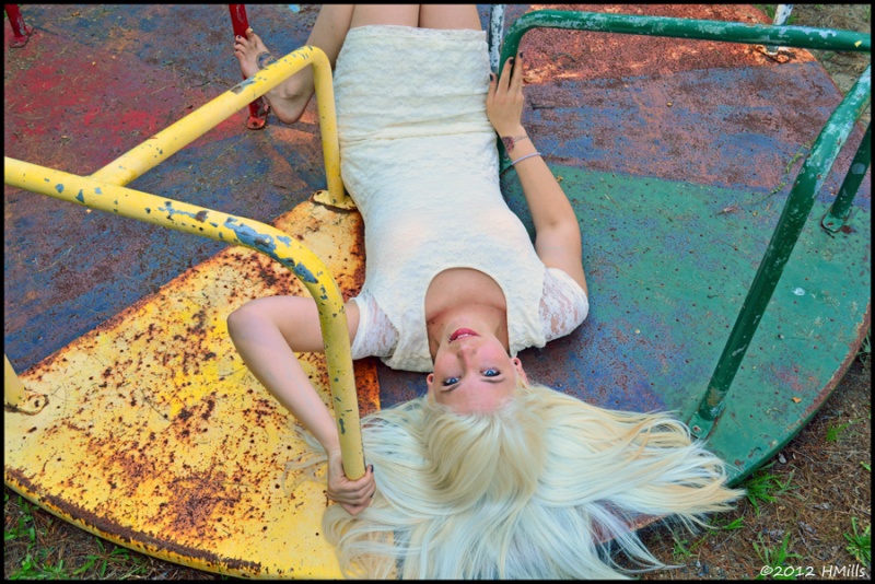 Female model photo shoot of Effie Marie by H Mills Photo in abandoned playground Salisbury MA