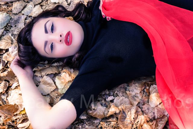 Female model photo shoot of Beauty Mark Studios in In the leaves lol