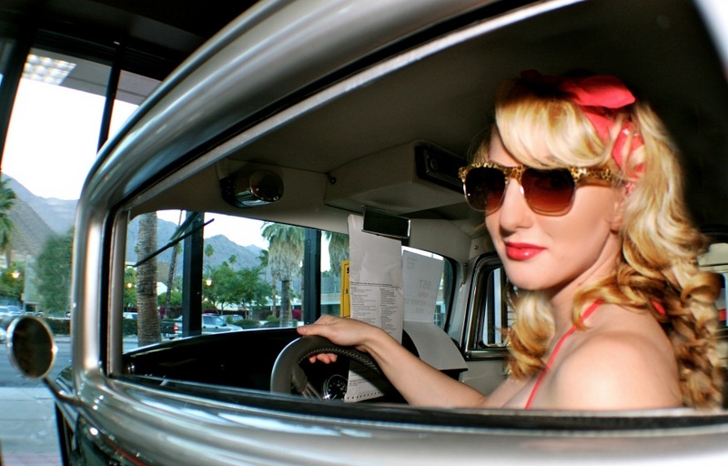 Female model photo shoot of AAAMartini in McCormicks Classic Cars showroom-palm Springs, CA