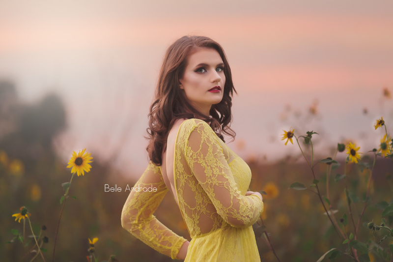 Female model photo shoot of Belle Andrade Photography and Caitlin Pennington in Sunflower field, makeup by Avelina Echavarria