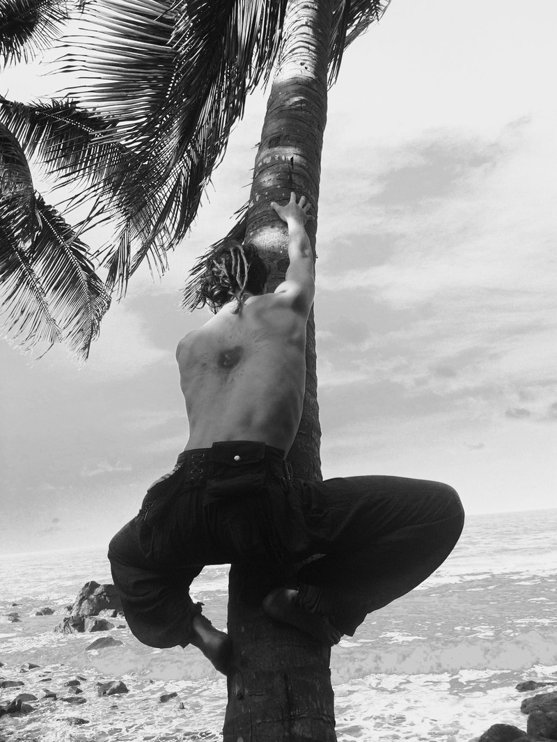Male model photo shoot of Silvere  in Up a coconut tree, Ghana