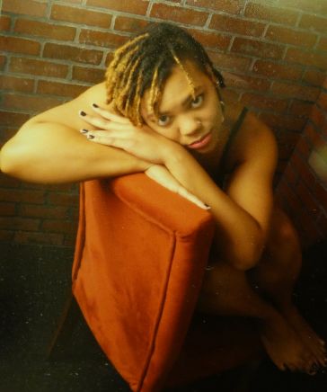 Female model photo shoot of Afro-333-Deity