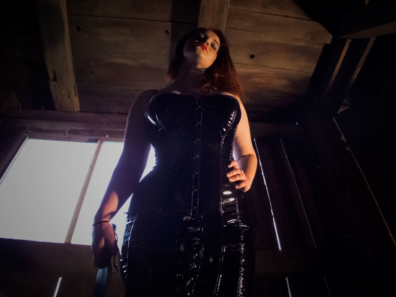 Female model photo shoot of Octavia Achten in Domina's personal dungeon