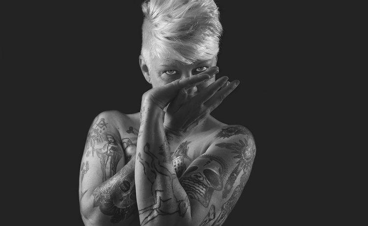 Female model photo shoot of dahlia tattoo